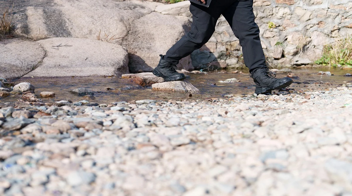 matching footwear to trail conditions with boots on rocky hiking terrain