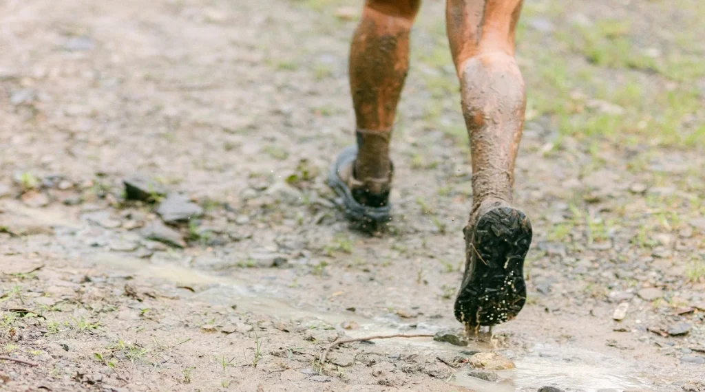 matching footwear to trail conditions on muddy ground with better trail grip