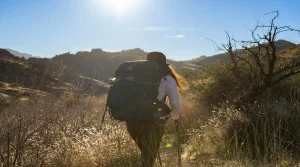 dry heat on hiking trails with a hiker moving through exposed sunlit terrain
