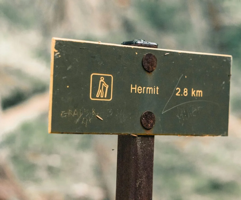 Hiker taking short steps on a trail with small footing warnings