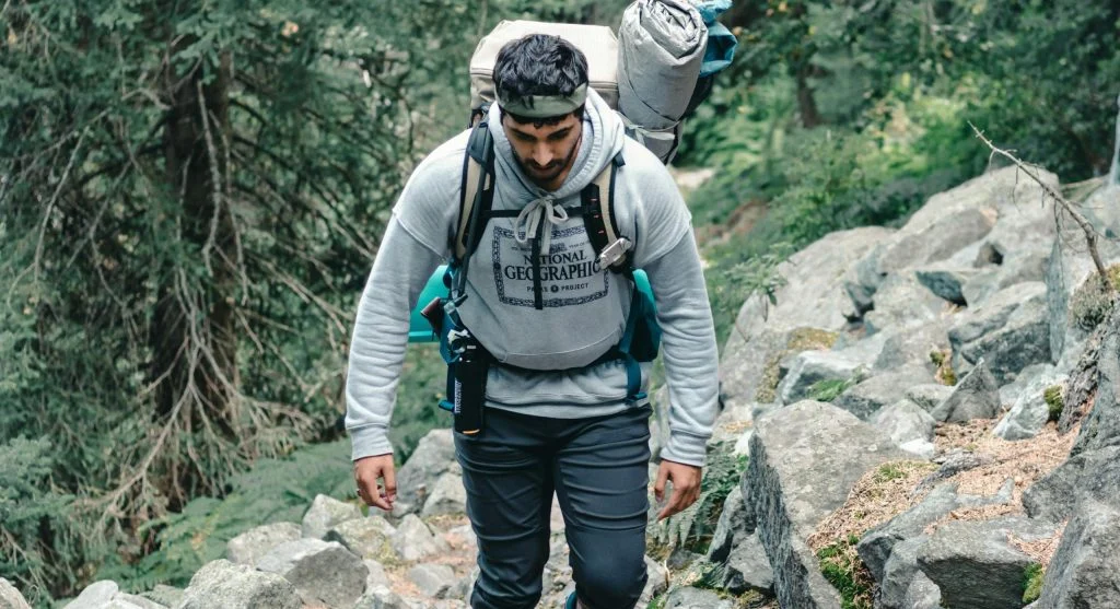 hiker wearing extra layer on trail