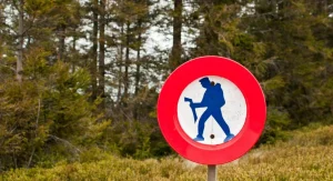 Hiker on trail with caution