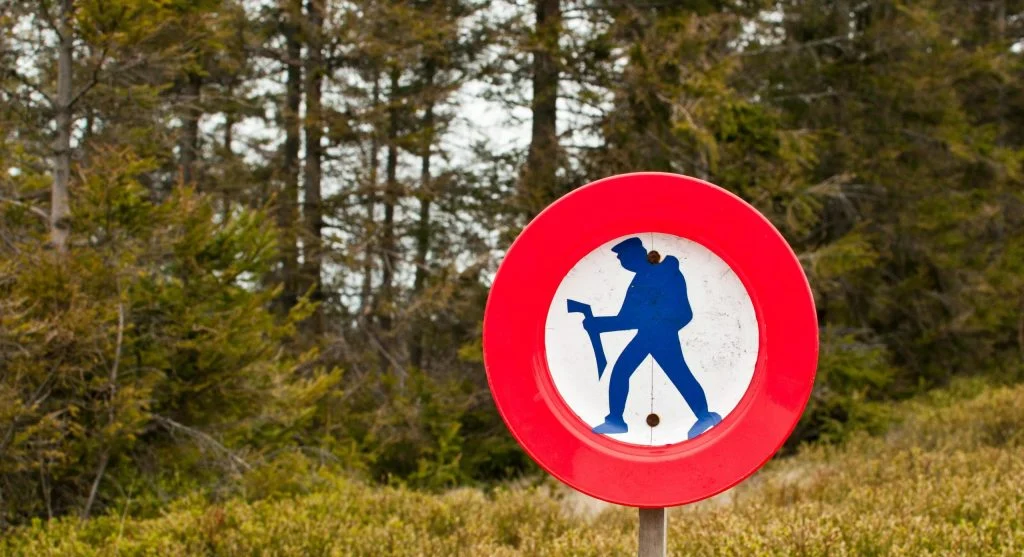 Hiker on trail with caution