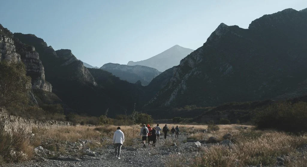 hiker looks back on trail edge