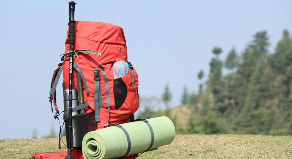 Hiker adjusting backpack on the trail