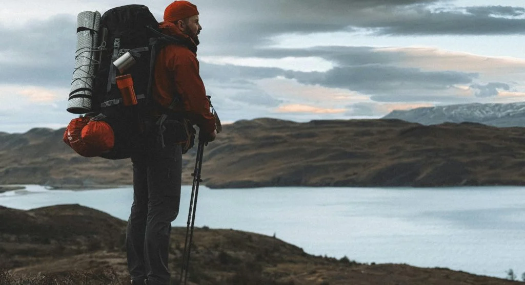 Hiker adjusting backpack straps