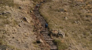 hiker on dry loose rocky trail