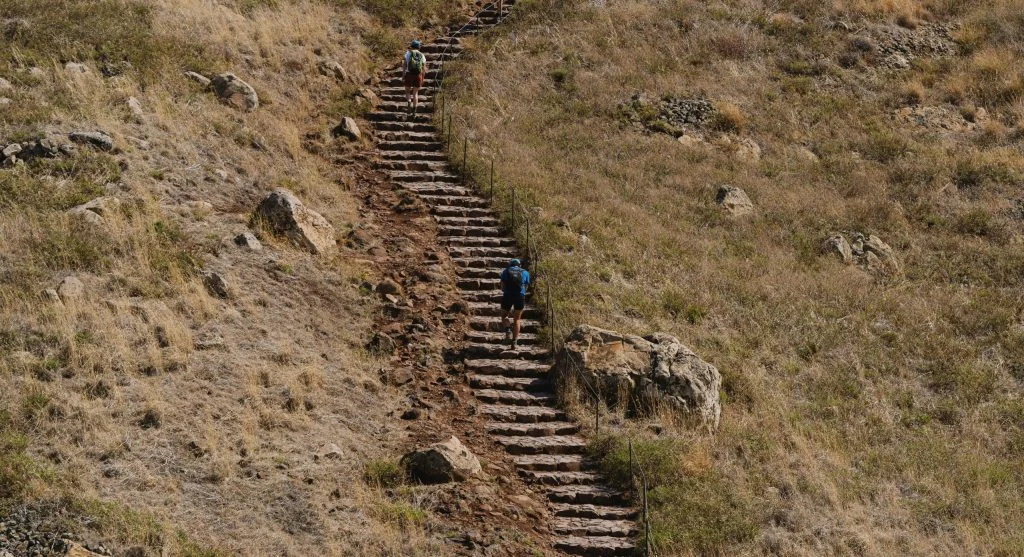 hiker on dry loose rocky trail