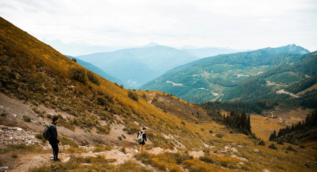 hiker looking back on mountain trail
