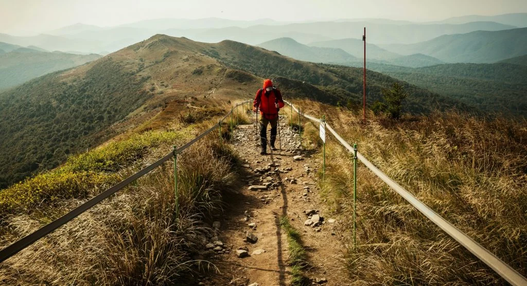 Hiker on a trail with repeated small climbs