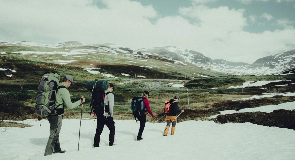 Cool wind after a climb is easier to manage when hikers add a layer before getting chilled