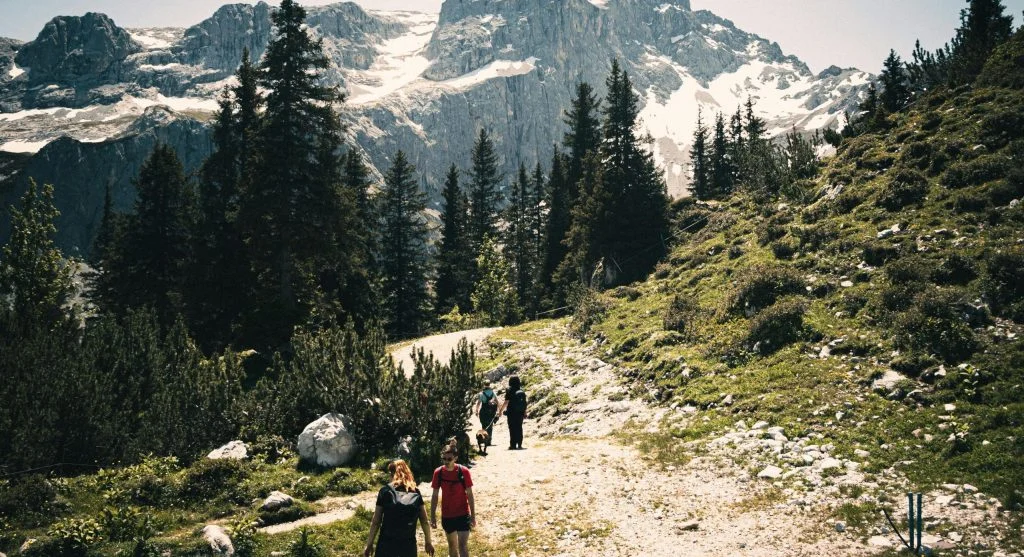 hiker planning trail with map and guide