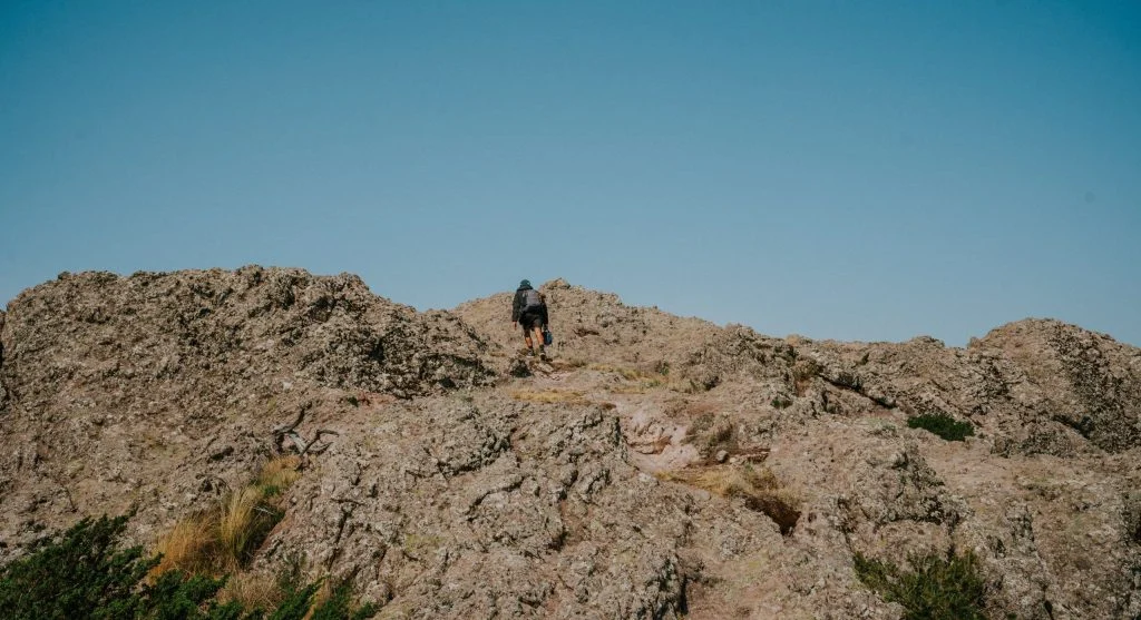 Hikers step too far forward on uneven trails when mixed ground hides small changes in support