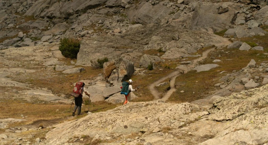 A trail is tilting sideways and changing how a hiker stands and balances