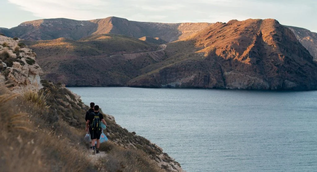 hiker drinking water on trail
