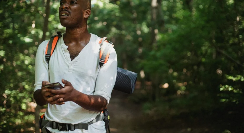 hiker checking map on trail