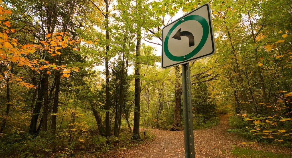 hiker on path with unclear signage